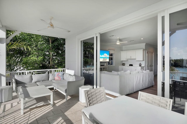 sunroom / solarium featuring ceiling fan