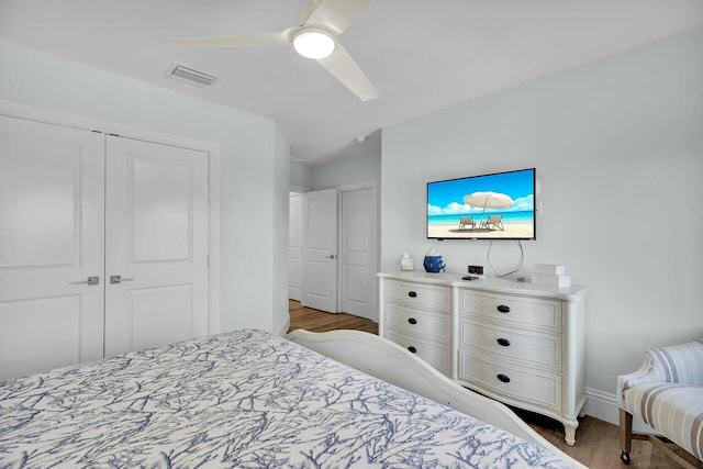bedroom featuring a closet, visible vents, ceiling fan, light wood-type flooring, and baseboards