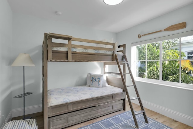bedroom with baseboards and wood finished floors