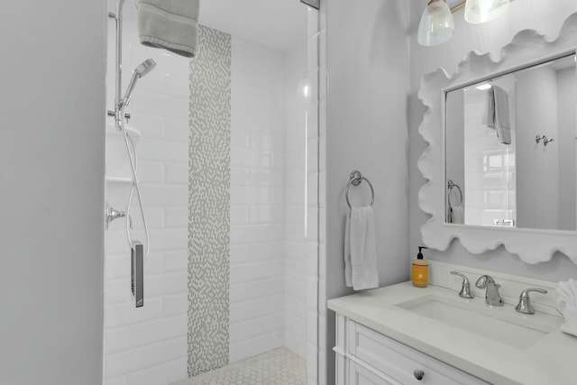 bathroom with a shower stall and vanity