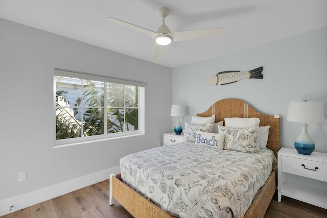 bedroom featuring ceiling fan, baseboards, and wood finished floors