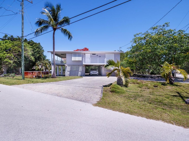 3806 Dyer Rd, Big Pine, FL 33043 - coastal home featuring driveway, a front yard, and a balcony