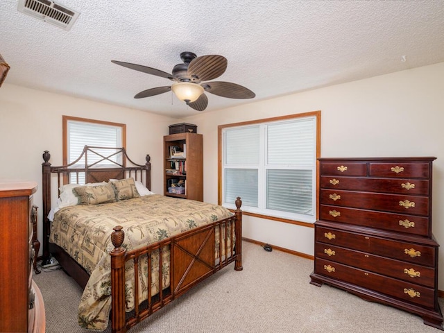 3806 Dyer Rd, Big Pine, FL 33043 - bedroom featuring light colored carpet, a textured ceiling, a ceiling fan, and baseboards