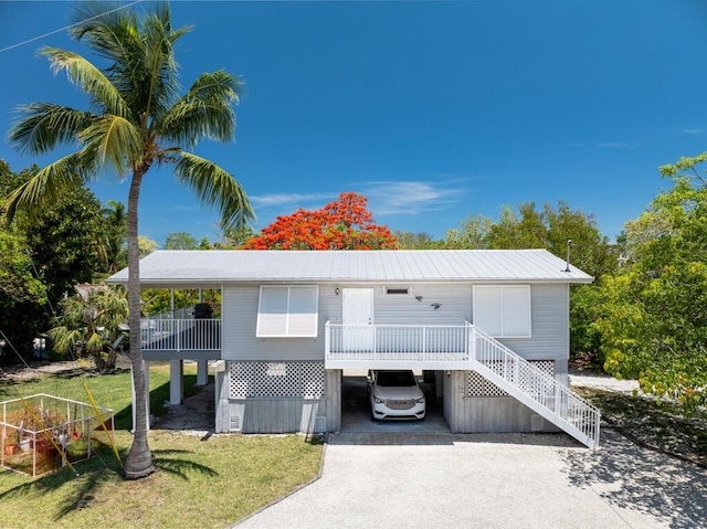 3806 Dyer Rd, Big Pine, FL 33043 - coastal home with a carport, driveway, a front yard, and stairs