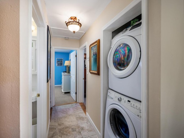 3806 Dyer Rd, Big Pine, FL 33043 - laundry room with stacked washer and clothes dryer, baseboards, and stone finish flooring