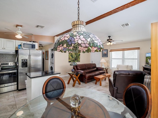 3806 Dyer Rd, Big Pine, FL 33043 - dining room featuring stacked washer and clothes dryer and a ceiling fan