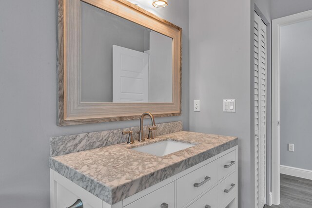 bathroom with vanity and hardwood / wood-style flooring