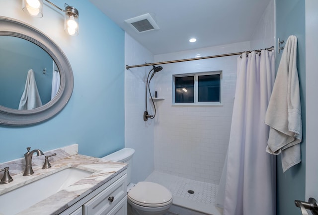 bathroom with vanity, curtained shower, and toilet