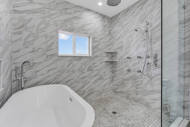 bathroom featuring shower with separate bathtub