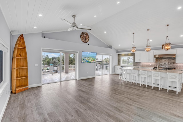 unfurnished living room featuring lofted ceiling, hardwood / wood-style floors, wooden ceiling, and ceiling fan