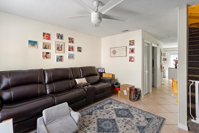 3397 Northside Dr Unit 4, Key West, FL 33040 - living room featuring a ceiling fan, stairway, light tile patterned floors, and a textured ceiling