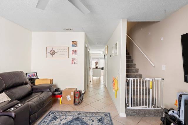 3397 Northside Dr Unit 4, Key West, FL 33040 - living room featuring light tile patterned floors, stairs, and a textured ceiling
