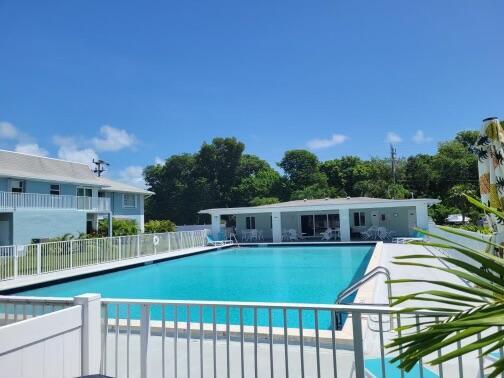 pool featuring a patio and fence