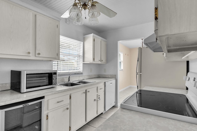 kitchen with ceiling fan, light tile patterned floors, plenty of natural light, white appliances, and a sink