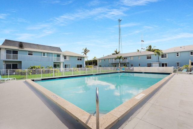 community pool with a residential view and fence