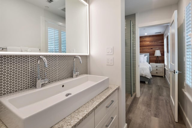 806 Southard St, Key West, FL 33040 - bathroom with vanity, decorative backsplash, visible vents, wood finished floors, and ensuite bathroom