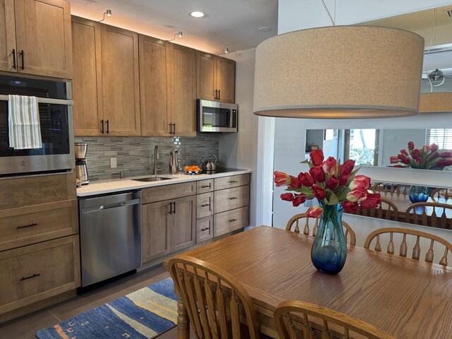 1728 Laird St, Key West, FL 33040 - kitchen featuring appliances with stainless steel finishes, a sink, light countertops, backsplash, and recessed lighting