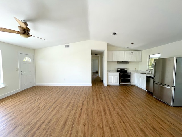 kitchen with appliances with stainless steel finishes, sink, light wood-type flooring, and white cabinets