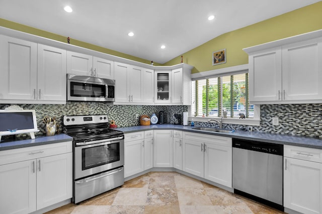 1 Sunset Rd, Key Largo, FL 33037 - kitchen with appliances with stainless steel finishes, dark countertops, white cabinets, tasteful backsplash, and recessed lighting