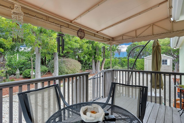 1 Sunset Rd, Key Largo, FL 33037 - wooden terrace featuring a storage shed and outdoor dining space