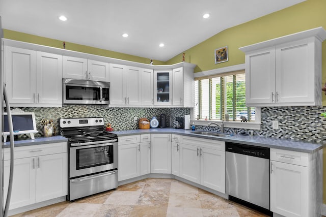1 Sunset Rd, Key Largo, FL 33037 - kitchen featuring appliances with stainless steel finishes, white cabinetry, backsplash, recessed lighting, and glass insert cabinets