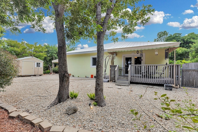 1 Sunset Rd, Key Largo, FL 33037 - view of front of property with stucco siding, a shed, and a metal roof
