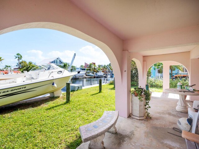 view of patio / terrace with a water view and a dock