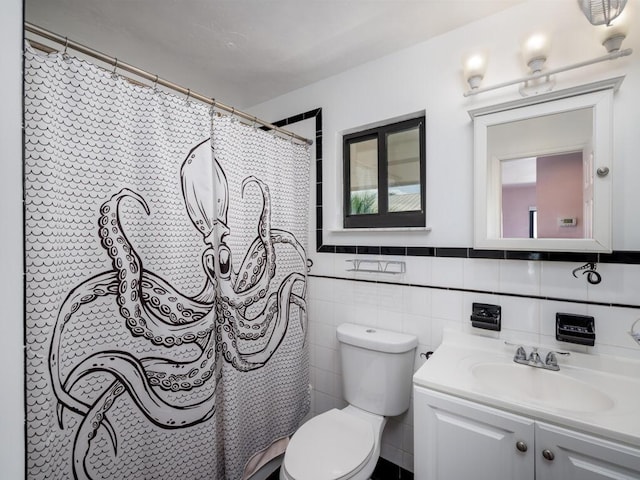 bathroom featuring vanity, tile walls, toilet, and walk in shower