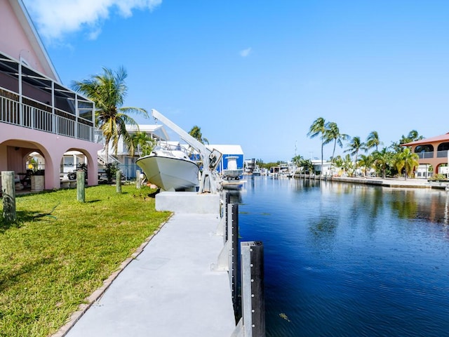 dock area featuring a water view and a lawn