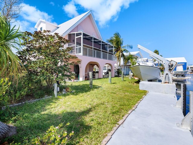 exterior space with a balcony and a lawn