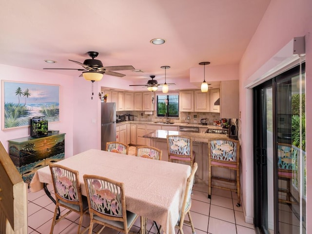 tiled dining room featuring sink