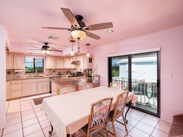 dining area with sink, light tile patterned floors, and ceiling fan