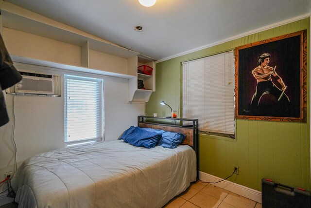 bedroom featuring light tile patterned flooring and crown molding