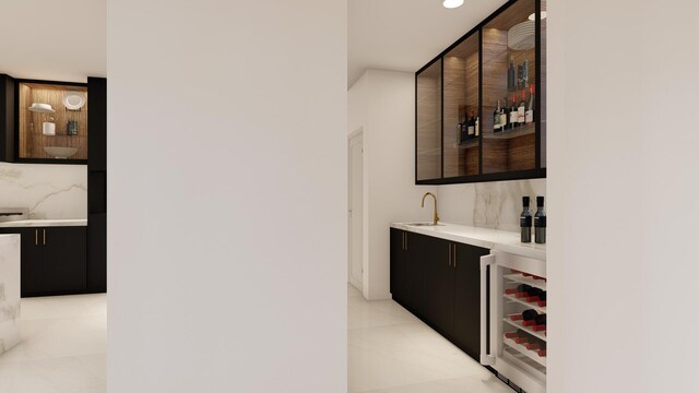 bar featuring beverage cooler and sink