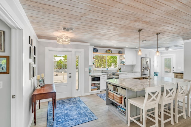 20735 W 5th Ave, Cudjoe, FL 33042 - kitchen featuring open shelves, wooden ceiling, white cabinetry, appliances with stainless steel finishes, and light stone countertops