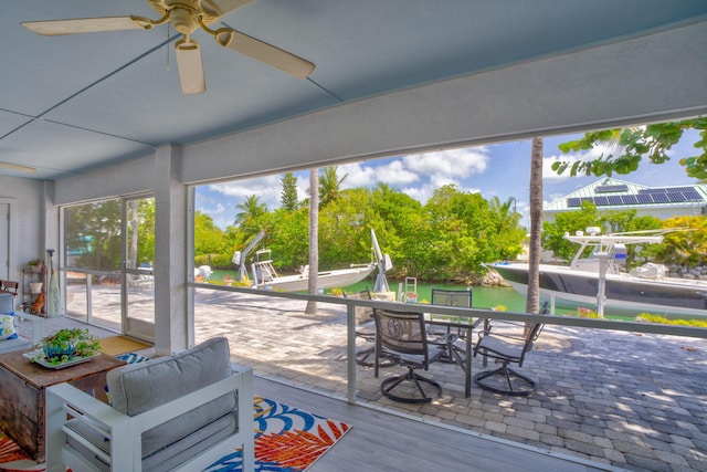 20735 W 5th Ave, Cudjoe, FL 33042 - sunroom / solarium featuring a ceiling fan, a water view, and outdoor dining area