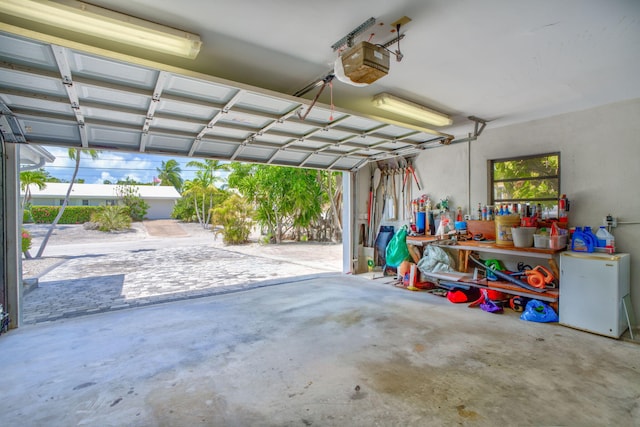 20735 W 5th Ave, Cudjoe, FL 33042 - garage featuring a garage door opener and a workshop area