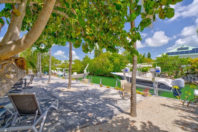 20735 W 5th Ave, Cudjoe, FL 33042 - view of patio / terrace featuring boat lift, a dock, and a water view