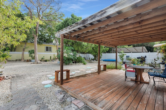 wooden terrace with a patio area