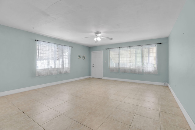 tiled empty room with ceiling fan