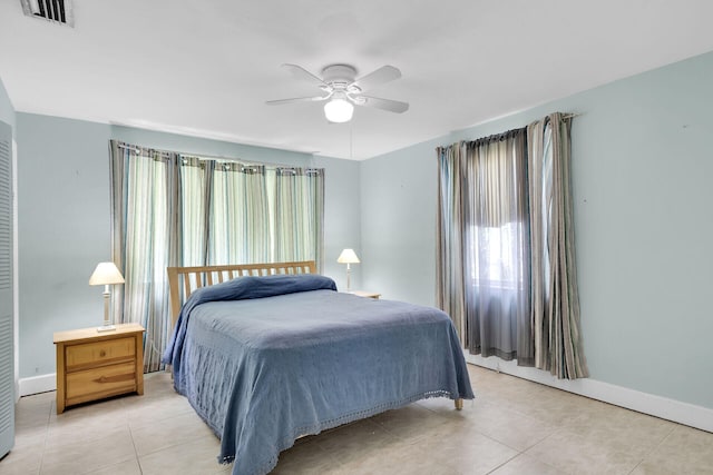 bedroom featuring light tile patterned floors and ceiling fan