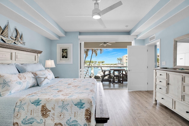 bedroom with a water view, ceiling fan, light wood-type flooring, and access to outside