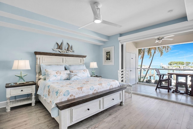 bedroom with access to exterior, light hardwood / wood-style flooring, and ceiling fan