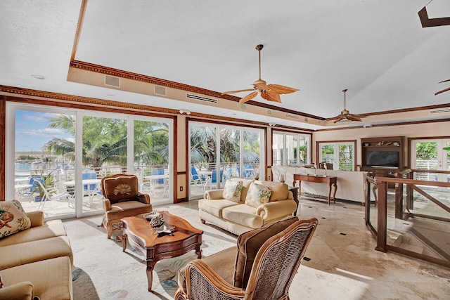 living room with a raised ceiling, ornamental molding, and ceiling fan