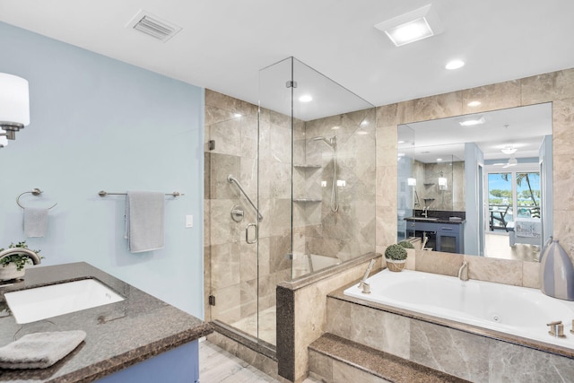 bathroom featuring independent shower and bath and vanity