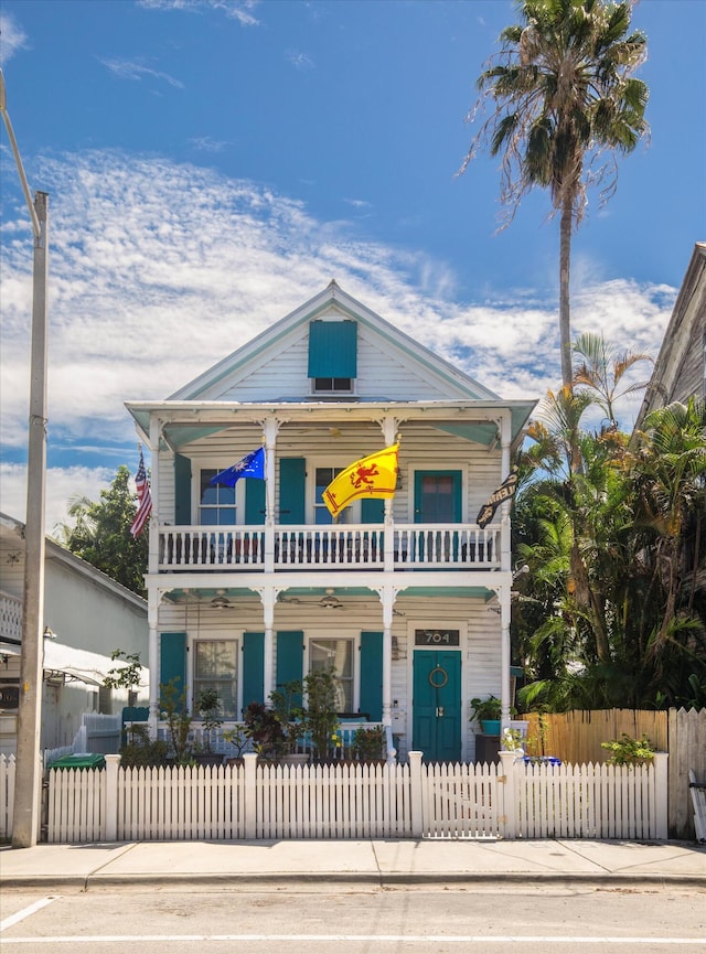 view of front facade with a balcony and covered porch