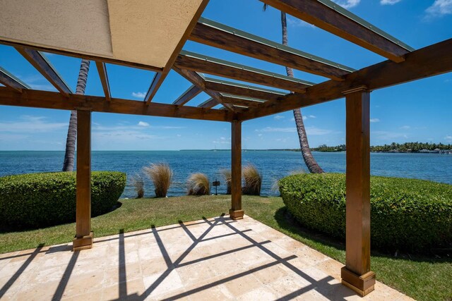 view of patio / terrace featuring a pergola and a water view