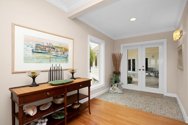 doorway featuring wood-type flooring, ornamental molding, and french doors