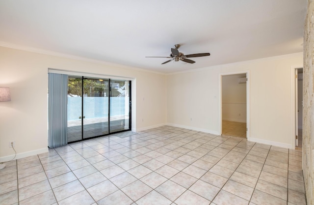 spare room with ornamental molding, baseboards, and ceiling fan