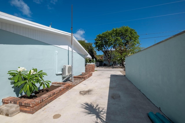 view of home's exterior with ac unit, stucco siding, and a patio